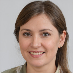 Joyful white young-adult female with medium  brown hair and grey eyes