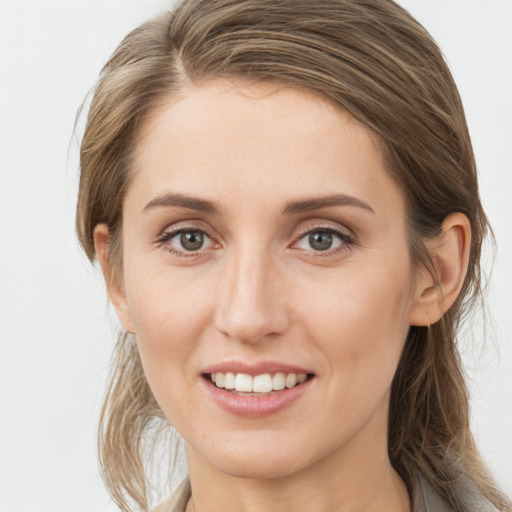 Joyful white young-adult female with medium  brown hair and blue eyes