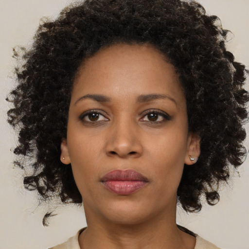 Neutral black young-adult female with medium  brown hair and brown eyes