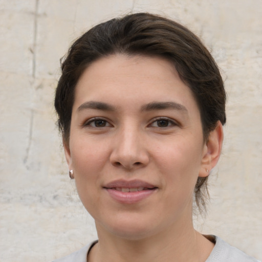 Joyful white young-adult female with medium  brown hair and brown eyes