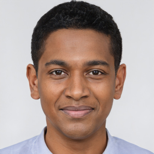 Joyful black young-adult male with short  black hair and brown eyes
