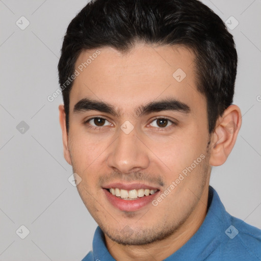 Joyful white young-adult male with short  black hair and brown eyes