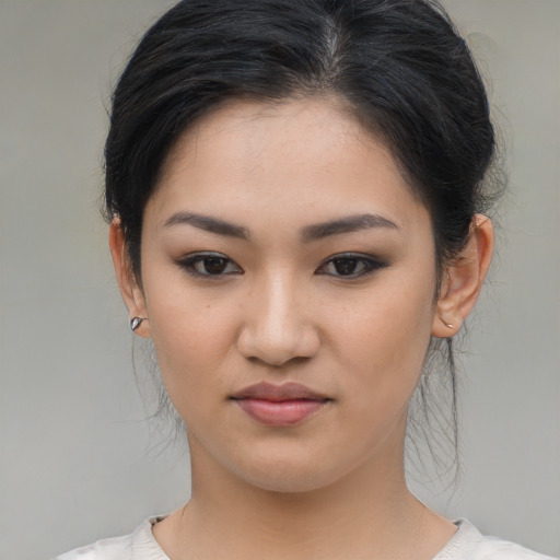 Joyful asian young-adult female with medium  brown hair and brown eyes
