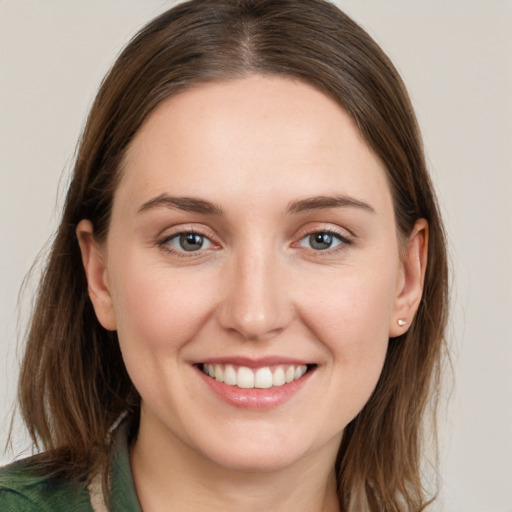 Joyful white young-adult female with long  brown hair and grey eyes