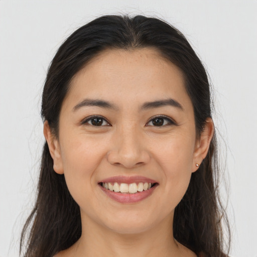 Joyful asian young-adult female with long  brown hair and brown eyes