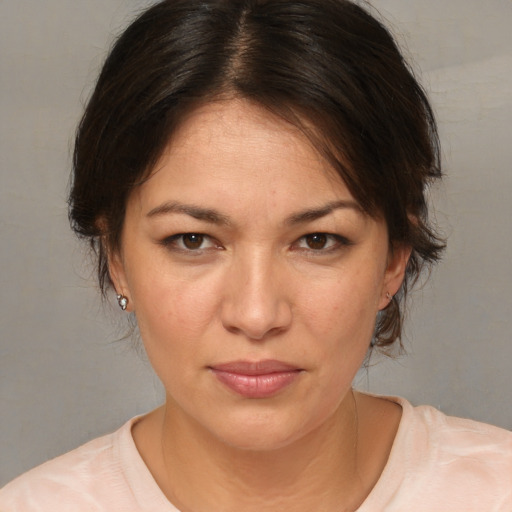 Joyful white adult female with medium  brown hair and brown eyes