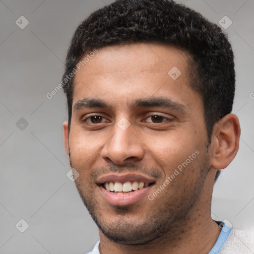 Joyful white young-adult male with short  black hair and brown eyes