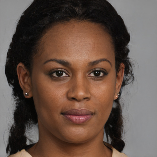 Joyful black young-adult female with medium  brown hair and brown eyes