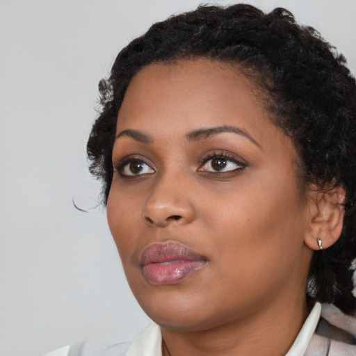 Joyful black young-adult female with medium  brown hair and brown eyes