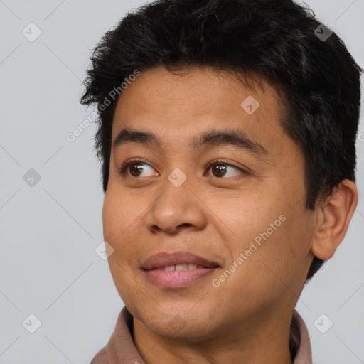 Joyful asian young-adult male with short  brown hair and brown eyes