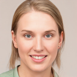 Joyful white young-adult female with medium  brown hair and blue eyes