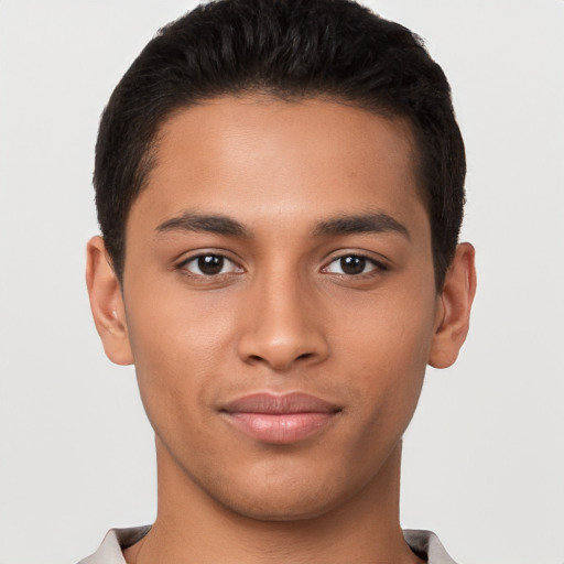 Joyful latino young-adult male with short  brown hair and brown eyes