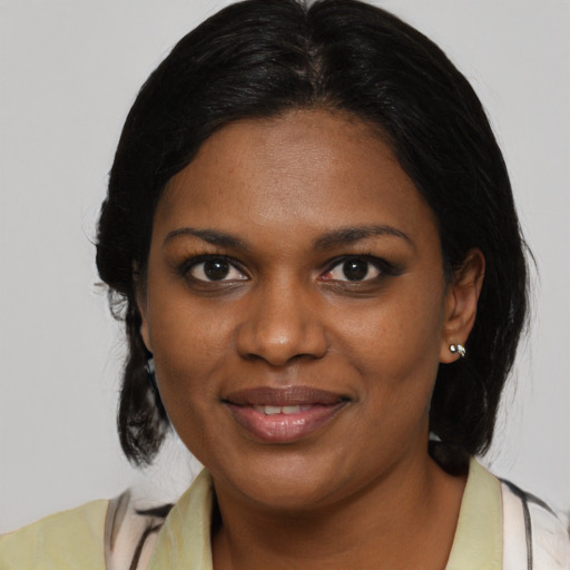 Joyful black young-adult female with medium  brown hair and brown eyes