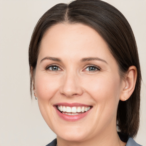 Joyful white young-adult female with medium  brown hair and brown eyes