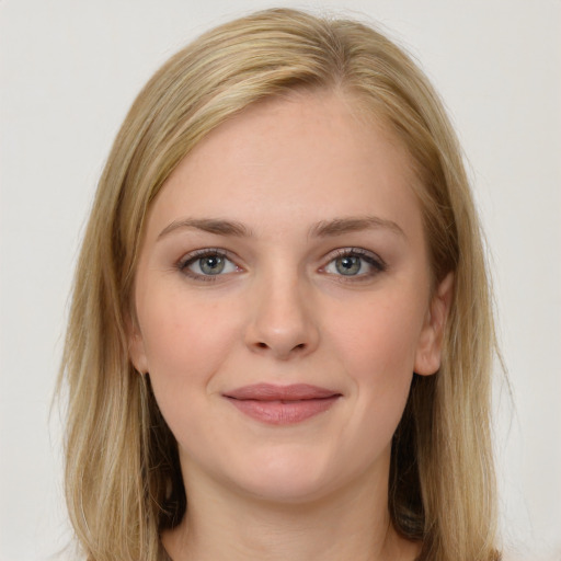 Joyful white young-adult female with long  brown hair and green eyes