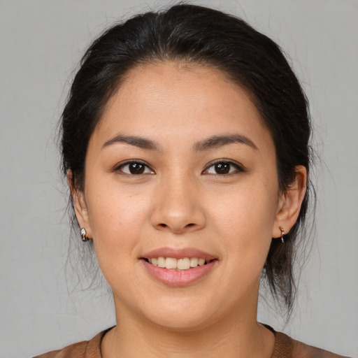 Joyful white young-adult female with medium  brown hair and brown eyes