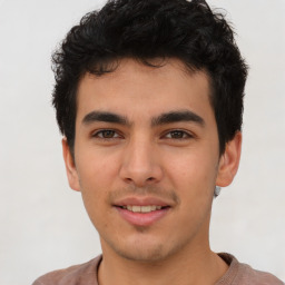 Joyful latino young-adult male with short  brown hair and brown eyes