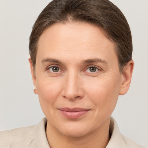 Joyful white adult female with short  brown hair and brown eyes