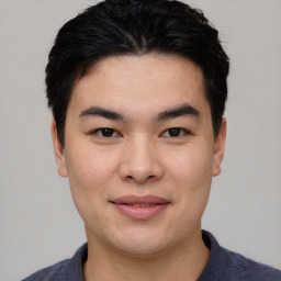 Joyful asian young-adult male with short  black hair and brown eyes