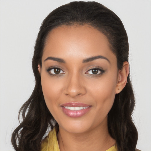 Joyful latino young-adult female with long  brown hair and brown eyes