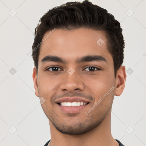 Joyful white young-adult male with short  black hair and brown eyes