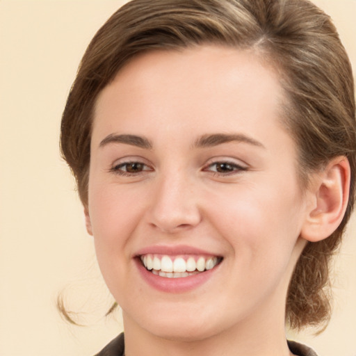 Joyful white young-adult female with medium  brown hair and green eyes