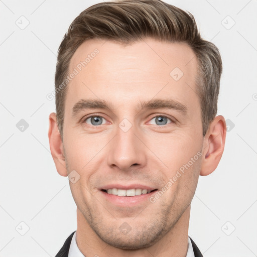 Joyful white young-adult male with short  brown hair and grey eyes