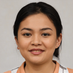 Joyful latino young-adult female with medium  brown hair and brown eyes