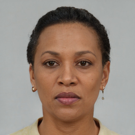 Neutral latino adult female with short  black hair and brown eyes
