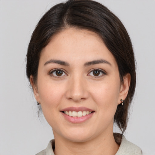 Joyful white young-adult female with medium  brown hair and brown eyes