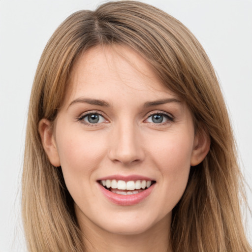 Joyful white young-adult female with long  brown hair and grey eyes