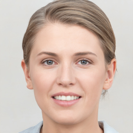 Joyful white young-adult female with short  brown hair and grey eyes