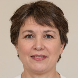 Joyful white adult female with short  brown hair and brown eyes