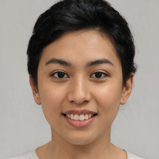 Joyful asian young-adult female with short  brown hair and brown eyes