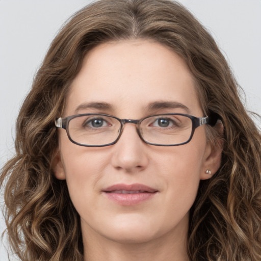 Joyful white young-adult female with long  brown hair and green eyes