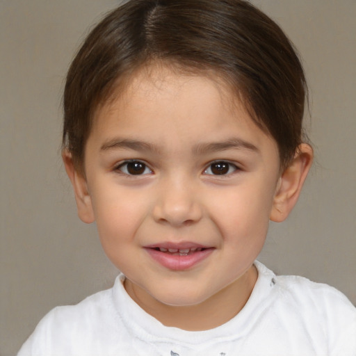 Joyful white child female with short  brown hair and brown eyes