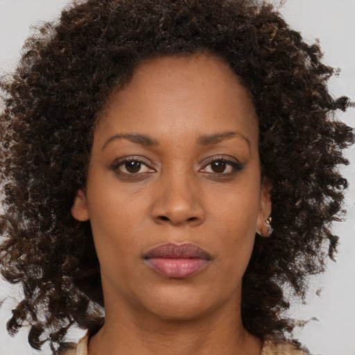 Neutral black young-adult female with medium  brown hair and brown eyes