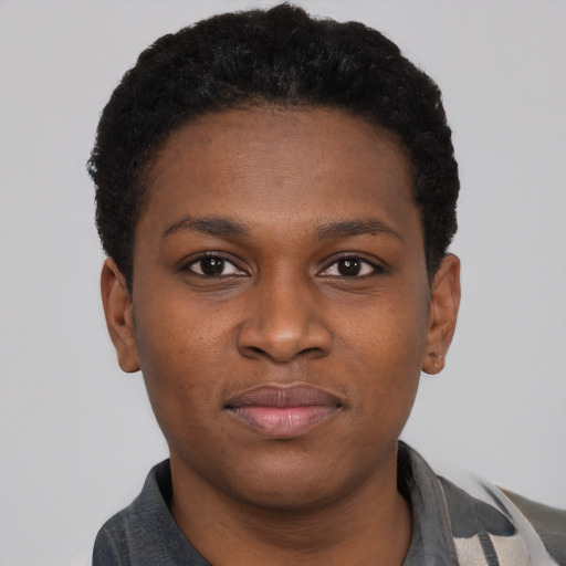 Joyful black young-adult female with short  brown hair and brown eyes