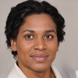 Joyful black adult female with short  brown hair and brown eyes