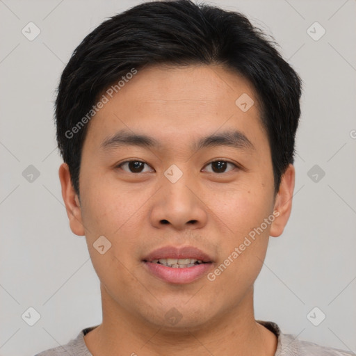 Joyful asian young-adult male with short  brown hair and brown eyes