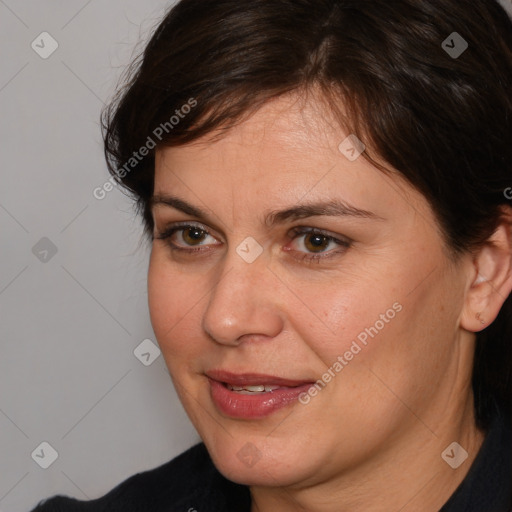 Joyful white adult female with medium  brown hair and brown eyes