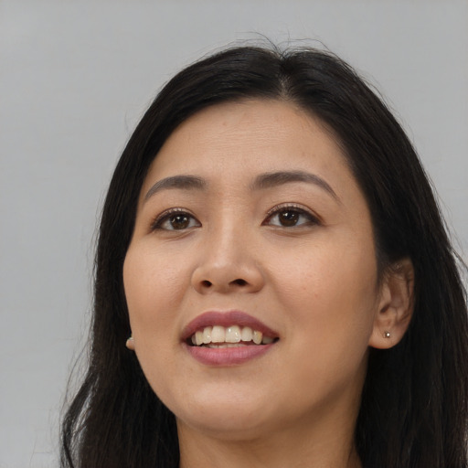 Joyful asian young-adult female with long  black hair and brown eyes