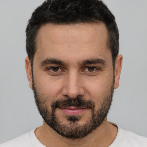 Joyful white young-adult male with short  brown hair and brown eyes