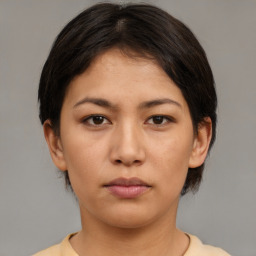 Neutral asian young-adult female with medium  brown hair and brown eyes