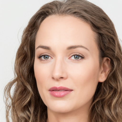 Joyful white young-adult female with long  brown hair and green eyes