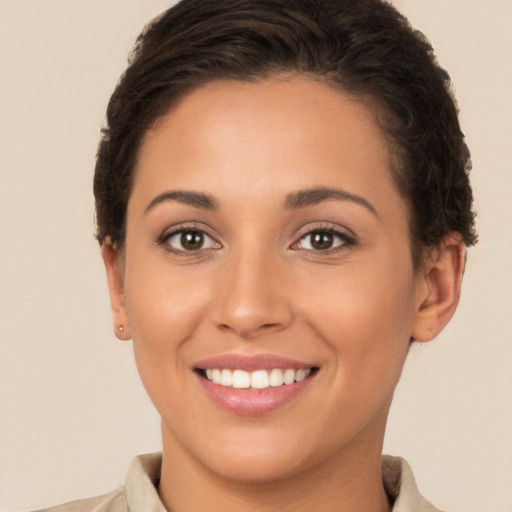 Joyful white young-adult female with short  brown hair and brown eyes