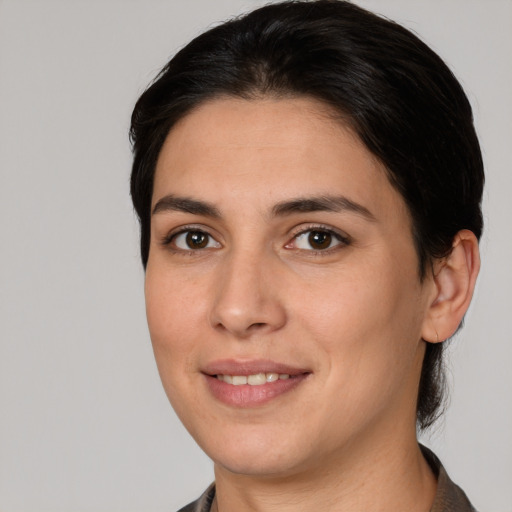 Joyful white young-adult female with medium  brown hair and brown eyes