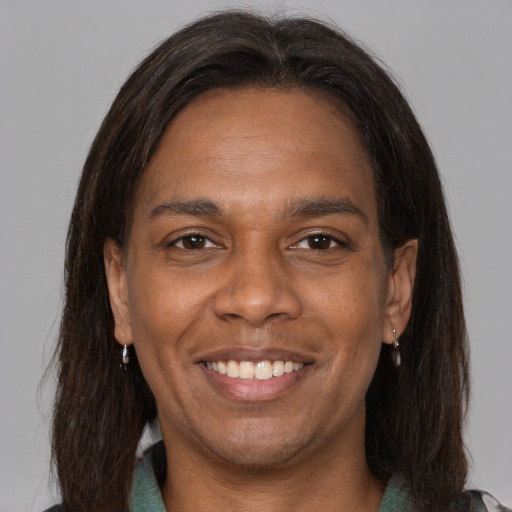Joyful black adult male with medium  brown hair and brown eyes