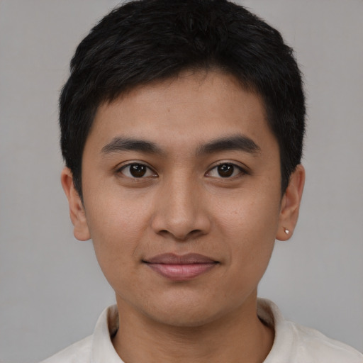 Joyful asian young-adult male with short  black hair and brown eyes
