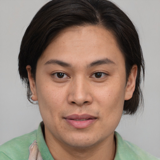 Joyful asian young-adult male with medium  brown hair and brown eyes